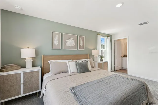 a bedroom with a bed and a lamp