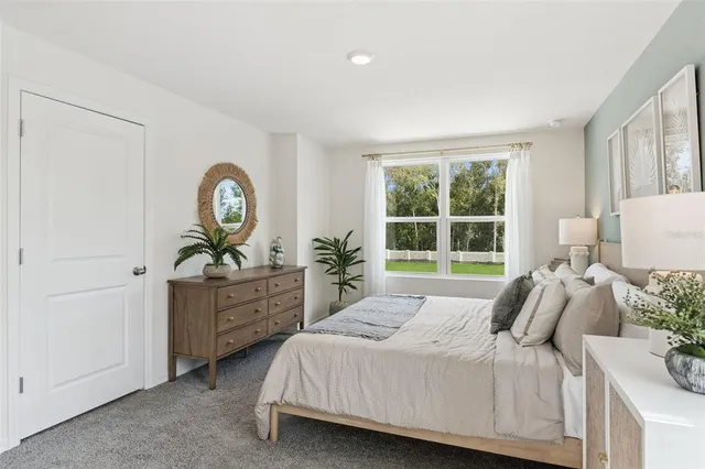 a bedroom with a bed and a dresser