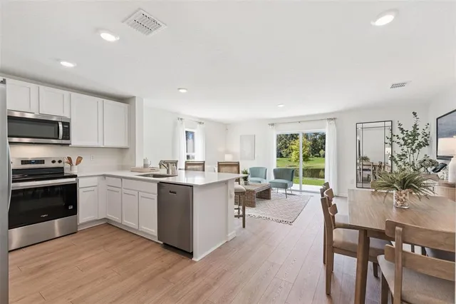 a kitchen with sink a stove and cabinets