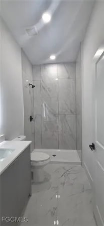 a bathroom with a shower a toilet and sink