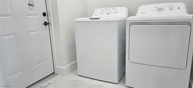 a utility room with dryer and washer