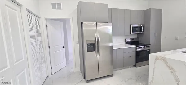 a kitchen with a refrigerator sink and stove