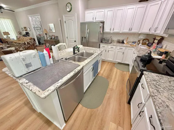 a kitchen with a sink appliances and cabinets