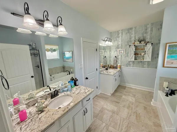 a spacious bathroom with a sink double vanity and a mirror