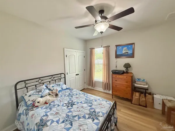 a bedroom with a bed and a dresser in it