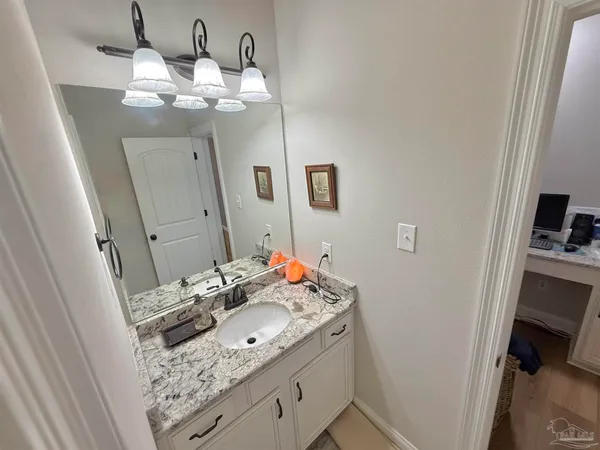 a bathroom with a sink vanity and a mirror