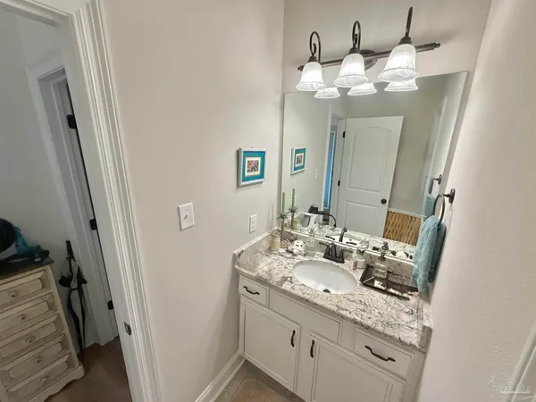 a bathroom with a sink vanity and a mirror