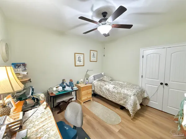 a bedroom with a bed and a chandelier