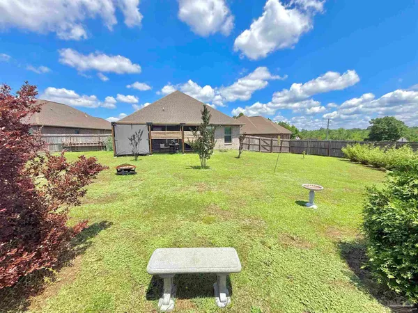 a swimming pool with outdoor seating and yard