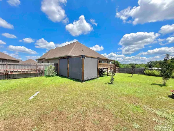 a view of an house with backyard and patio