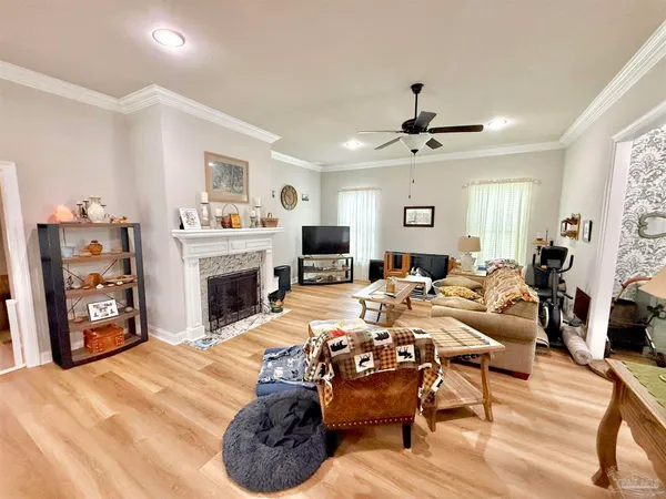 a living room with furniture a fireplace and a flat screen tv