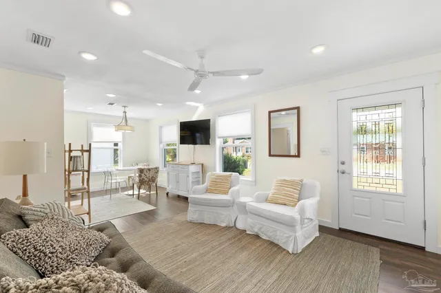 a living room with furniture and a wooden floor