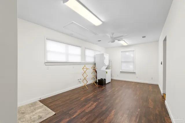 an empty room with wooden floor and a window