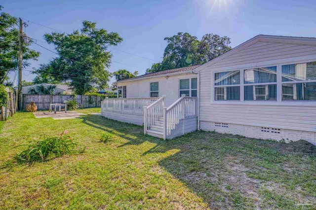 a view of a house with a yard and sitting area