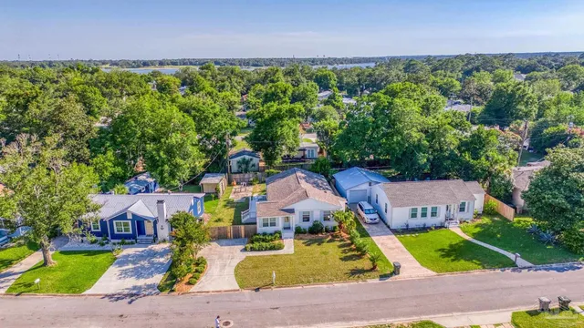 an aerial view of a house with garden space and street view