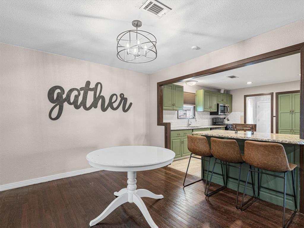1308 Myrtle Street Denton, TX 76201 - Photo 14 of 35 a kitchen with a table and chairs in it