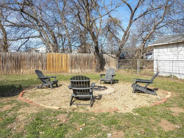 a view of backyard with wooden fence and sitting area