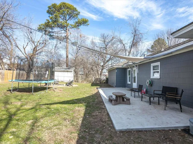 a view of a backyard with table and chairs