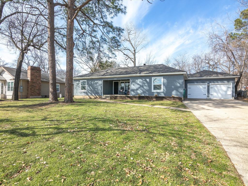 1308 Myrtle Street Denton, TX 76201 - Photo 5 of 35 a front view of a house with a garden