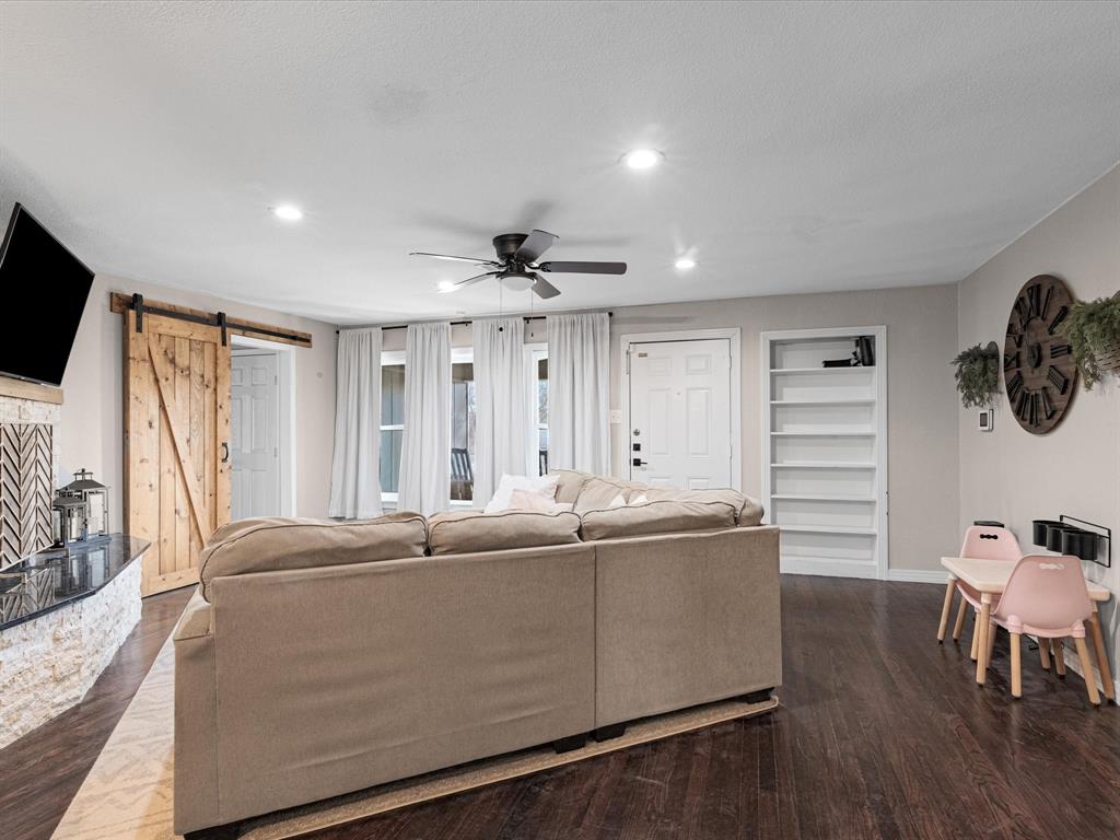 1308 Myrtle Street Denton, TX 76201 - Photo 8 of 35 a living room with furniture a flat screen tv and a large window