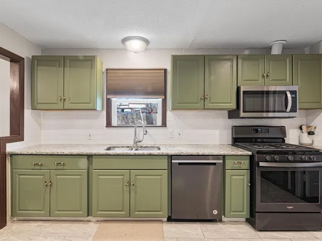 a kitchen with a sink and stainless steel appliances