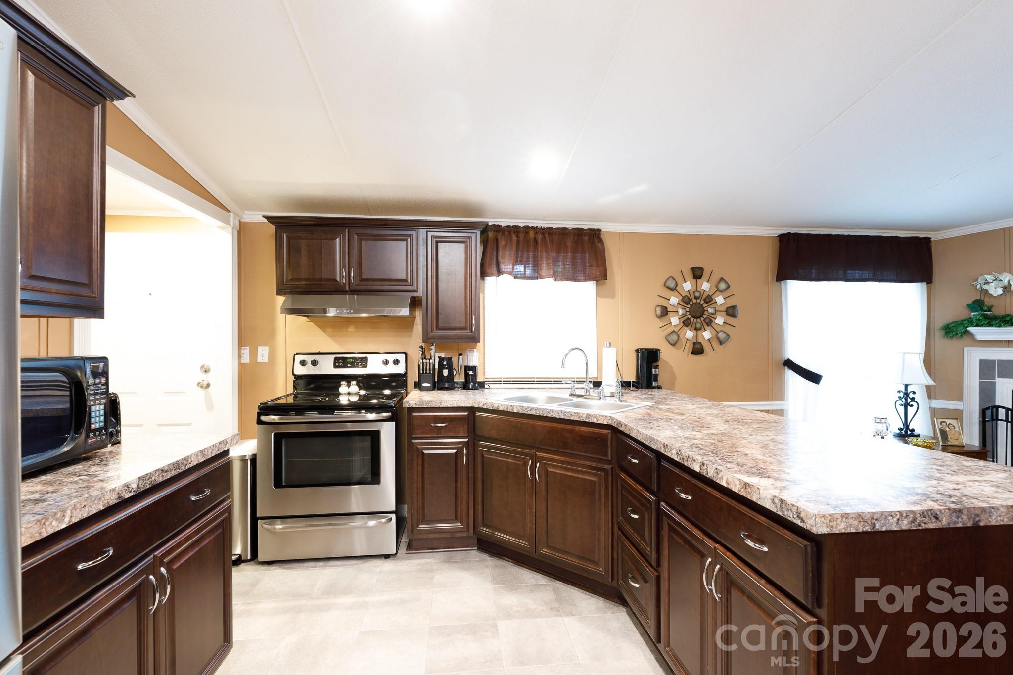 652 Sutton Spring Road York, SC 29745 - Photo 9 of 28 a kitchen with stainless steel appliances granite countertop a sink stove and oven