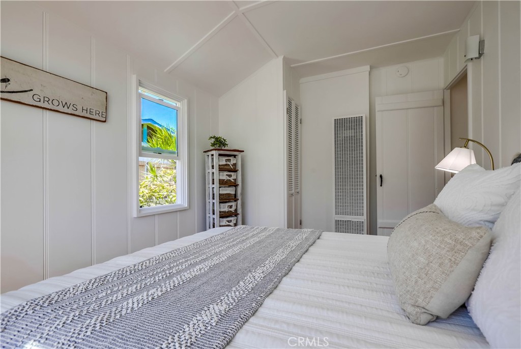 464 Agate Street, Unit A/B Laguna Beach, CA 92651 - Photo 27 of 75 a bedroom with a bed and a window