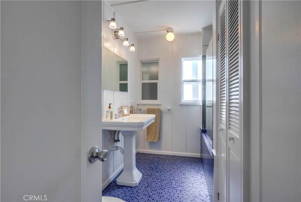 464 Agate Street, Unit A/B Laguna Beach, CA 92651 - Photo 28 of 75 a bathroom with a sink a mirror and a shower