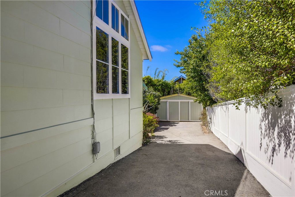464 Agate Street, Unit A/B Laguna Beach, CA 92651 - Photo 32 of 75 a view of backyard with large tree and wooden fence