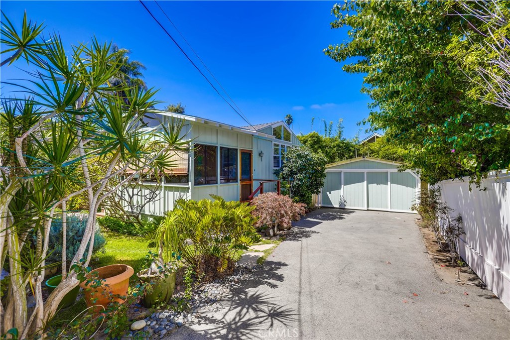 464 Agate Street, Unit A/B Laguna Beach, CA 92651 - Photo 33 of 75 a view of a house with potted plants and large trees