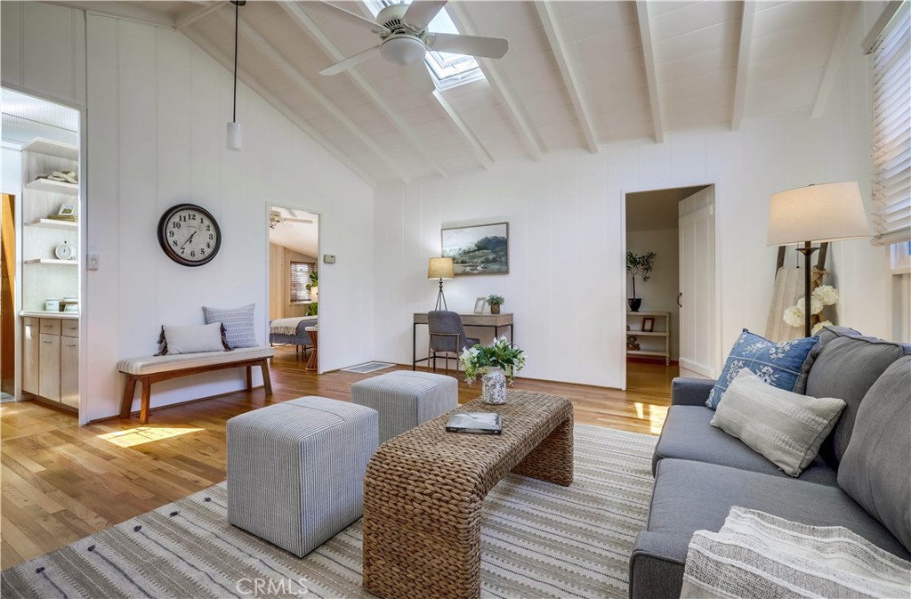 464 Agate Street, Unit A/B Laguna Beach, CA 92651 - Photo 44 of 75 a living room with furniture a clock on wall and a window