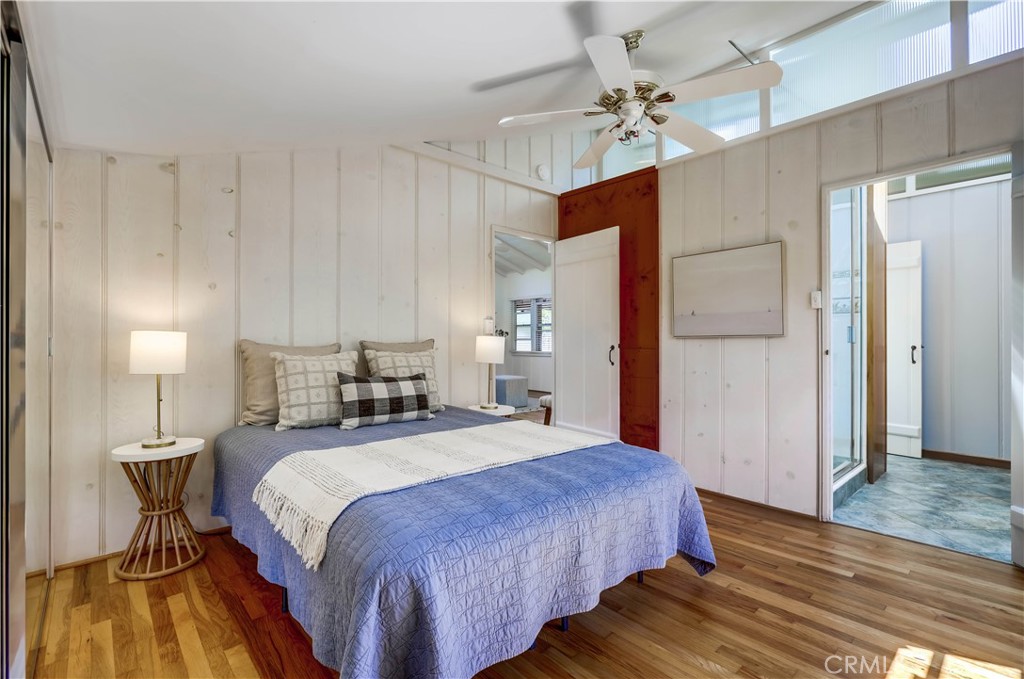464 Agate Street, Unit A/B Laguna Beach, CA 92651 - Photo 60 of 75 a spacious bedroom with a bed and a chandelier