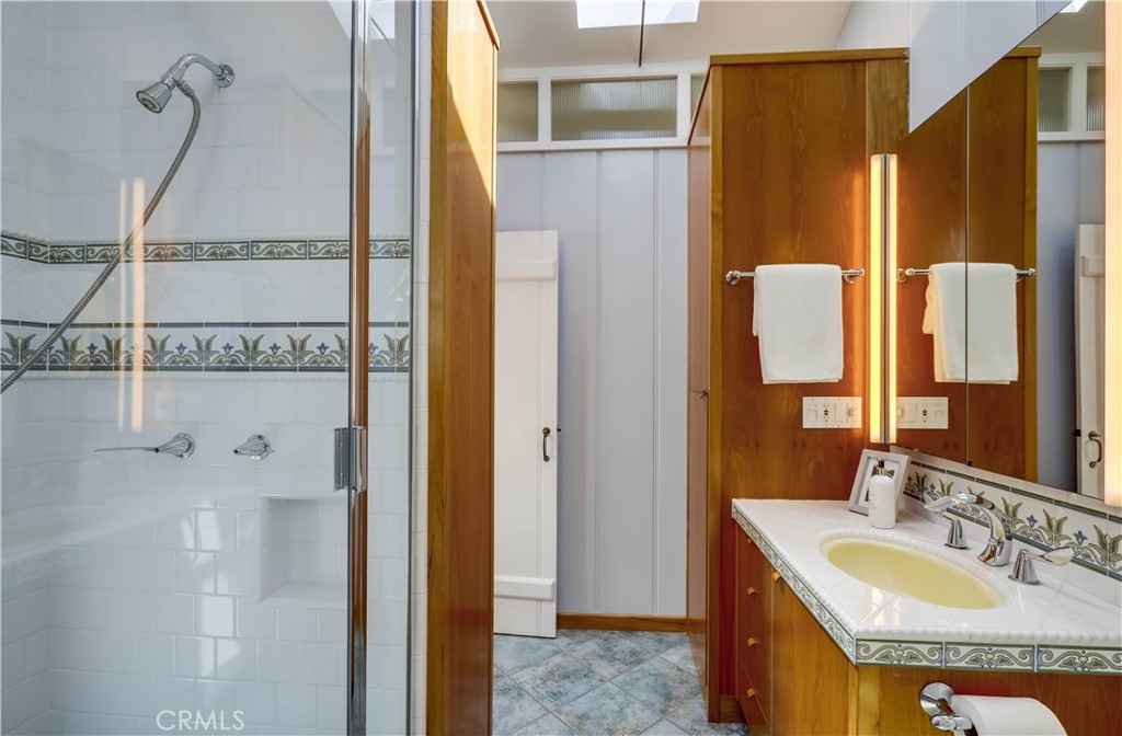 464 Agate Street, Unit A/B Laguna Beach, CA 92651 - Photo 66 of 75 a bathroom with a granite countertop shower and a sink