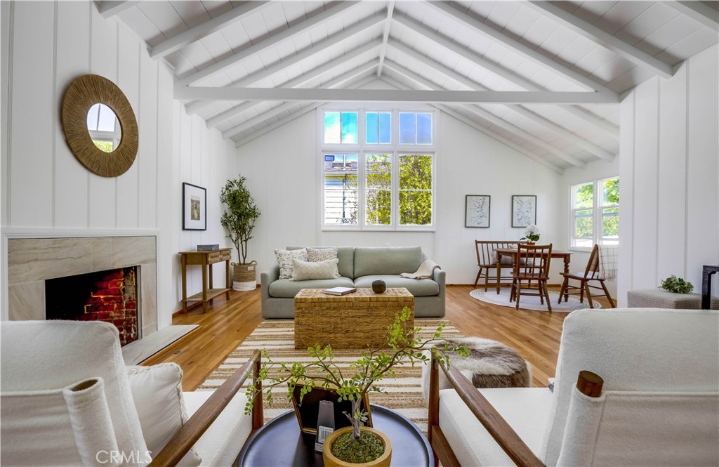 464 Agate Street, Unit A/B Laguna Beach, CA 92651 - Photo 7 of 75 a living room with furniture a chandelier and a fireplace