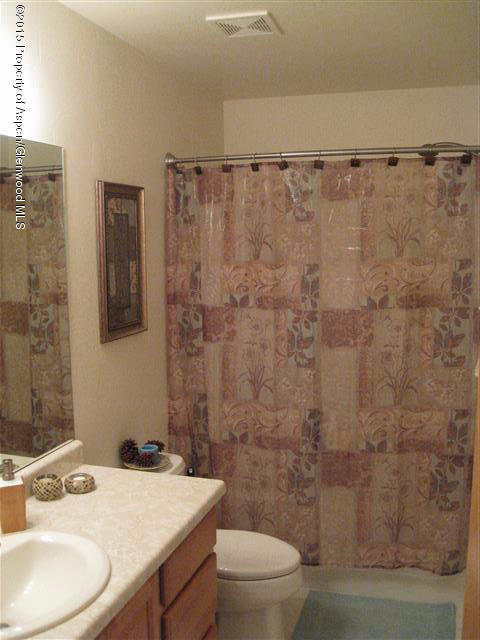 1067 East 18th Street Rifle, CO 81650 - Photo 13 of 14 a bathroom with a sink a toilet and shower