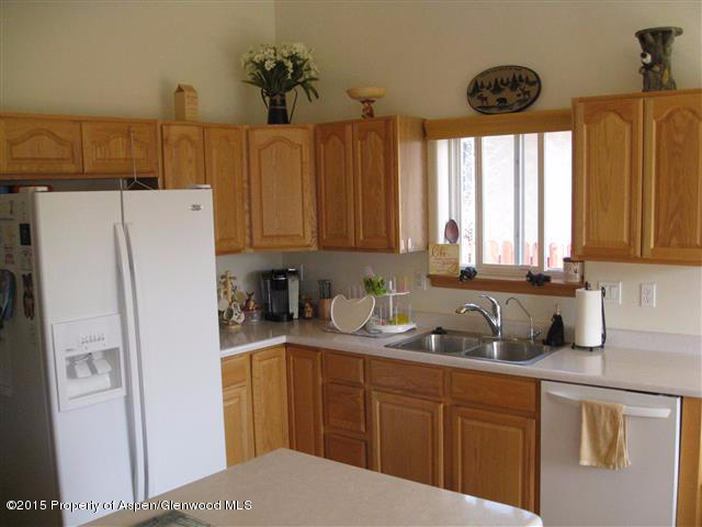 1067 East 18th Street Rifle, CO 81650 - Photo 3 of 14 a kitchen with stainless steel appliances a refrigerator sink and cabinets