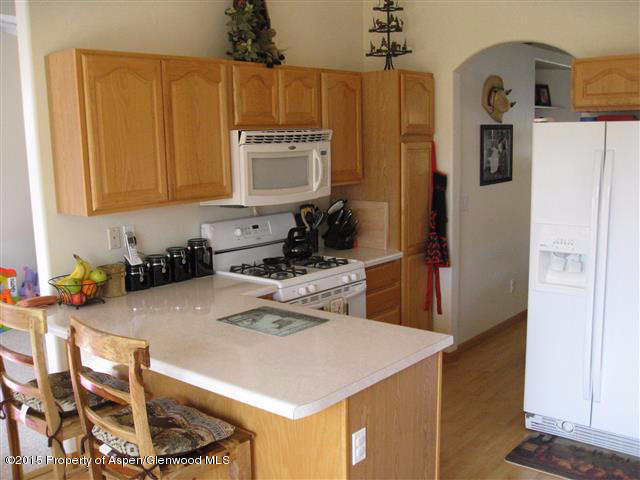 1067 East 18th Street Rifle, CO 81650 - Photo 4 of 14 a kitchen with a sink a stove and refrigerator