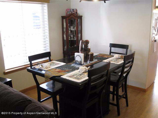 1067 East 18th Street Rifle, CO 81650 - Photo 5 of 14 a view of a dining room with furniture and wooden floor