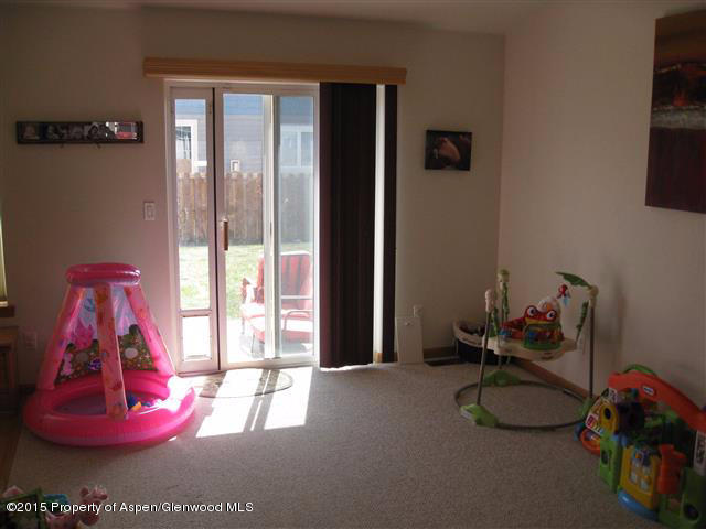 1067 East 18th Street Rifle, CO 81650 - Photo 9 of 14 a room with furniture and floor to ceiling window