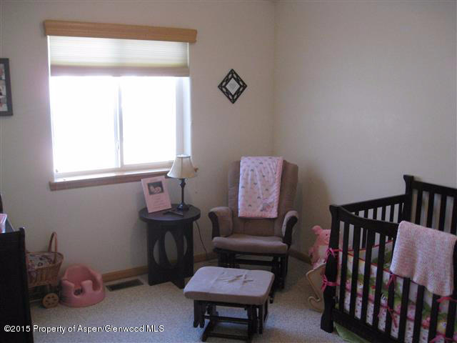 1067 East 18th Street Rifle, CO 81650 - Photo 10 of 14 a view of a workspace with furniture and a window