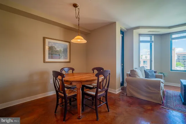 a bedroom with a bed and a table with potted plant
