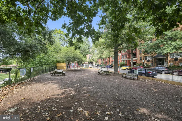 a group of people sitting in front of retail shops