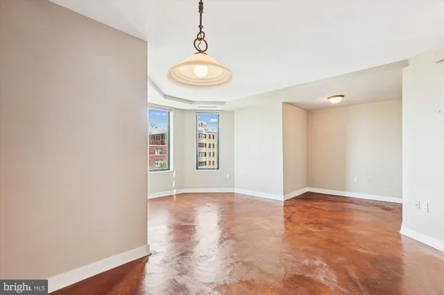 a view of a hallway with a dining table and chairs