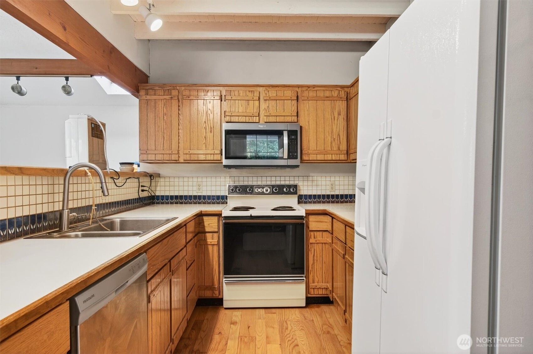 1015 Hazel Dell Road Castle Rock, WA 98611 - Photo 19 of 35 a kitchen with stainless steel appliances a stove sink and microwave