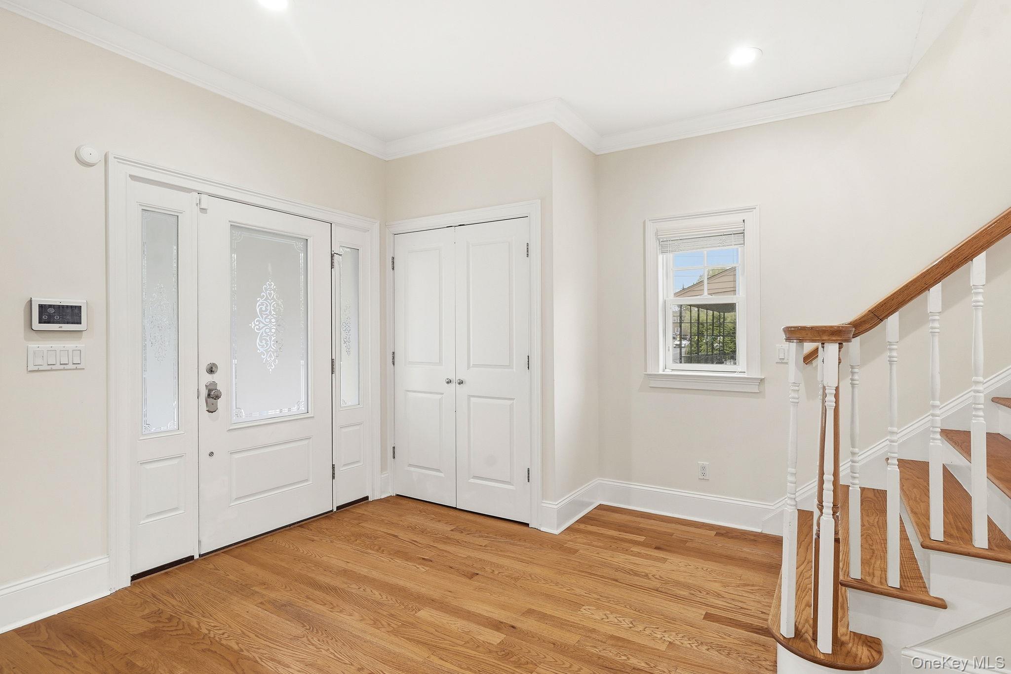 228 Central Avenue Rye, NY 10580 - Photo 3 of 24 a view of an empty room with wooden floor and a window