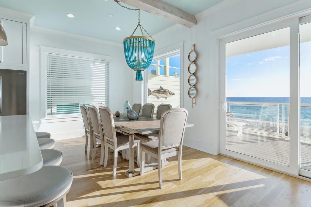 20405 Front Beach Road Panama City Beach, FL 32413 - Photo 12 of 130 a view of a dining room with furniture wooden floor and chandelier
