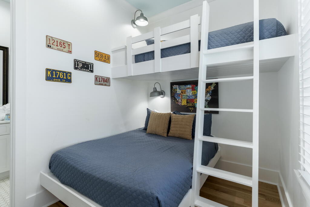 20405 Front Beach Road Panama City Beach, FL 32413 - Photo 85 of 130 a bed room with a bed and a book shelf