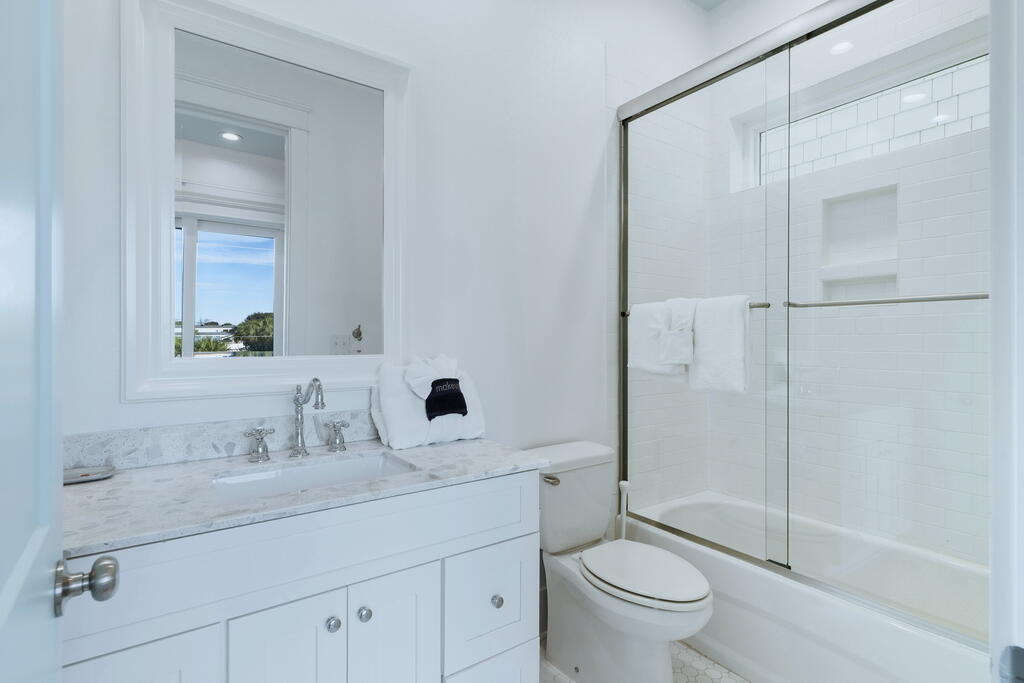 20405 Front Beach Road Panama City Beach, FL 32413 - Photo 86 of 130 a bathroom with a sink a toilet and shower