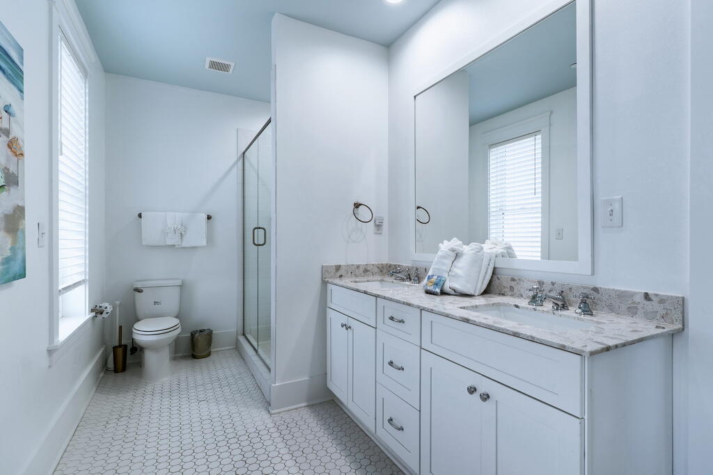 20405 Front Beach Road Panama City Beach, FL 32413 - Photo 95 of 130 a spacious bathroom with a granite countertop sink a toilet and a mirror
