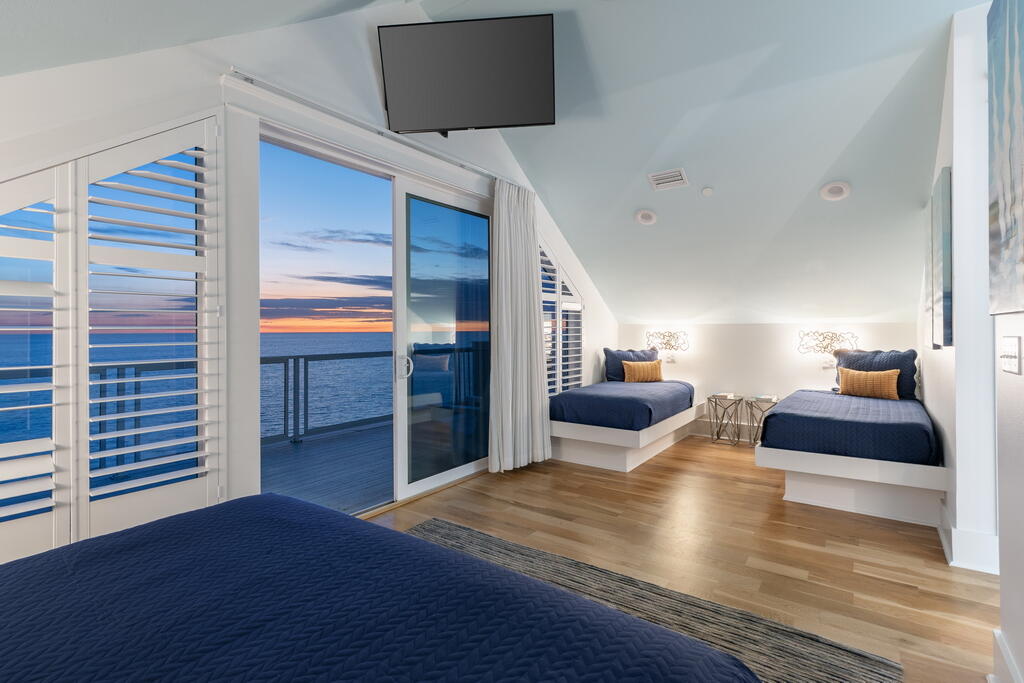 20405 Front Beach Road Panama City Beach, FL 32413 - Photo 100 of 130 a bedroom with a bed and wooden floor
